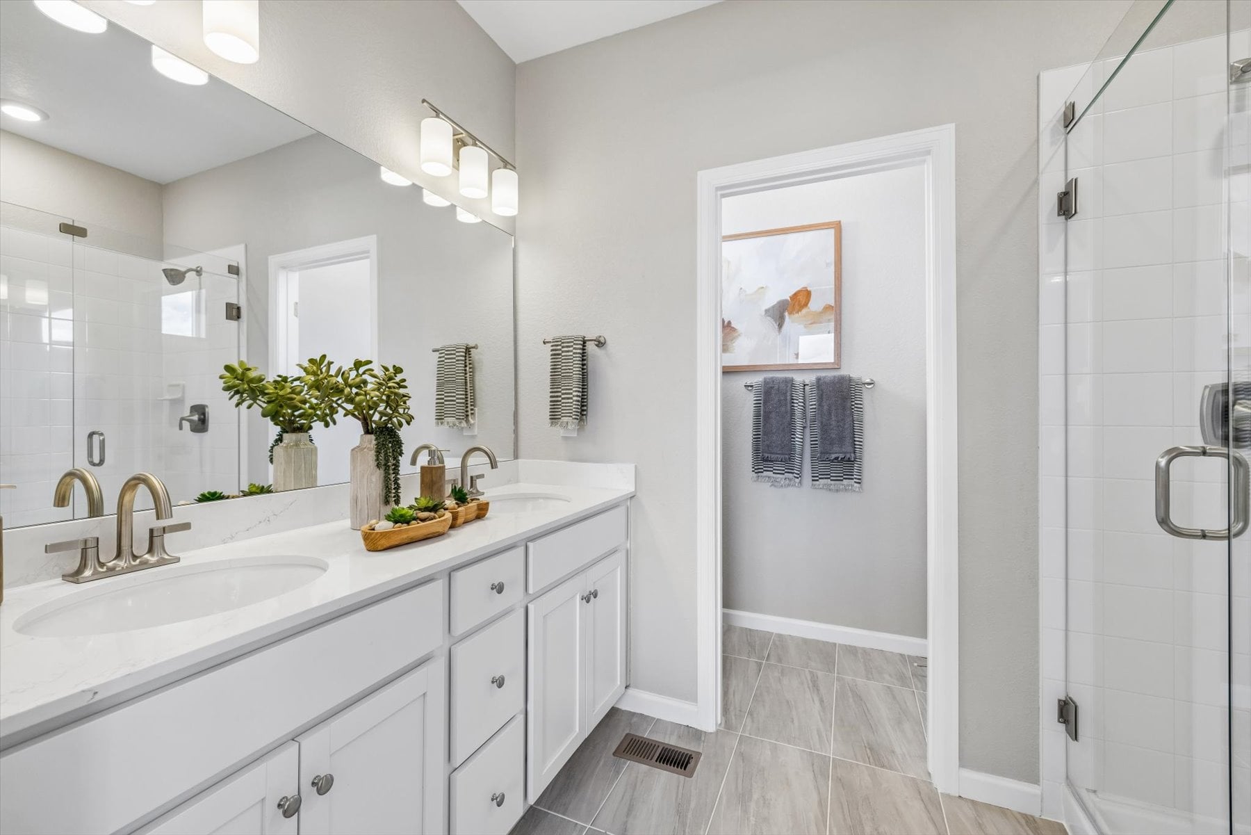 A bathroom with a sink and a shower unit.