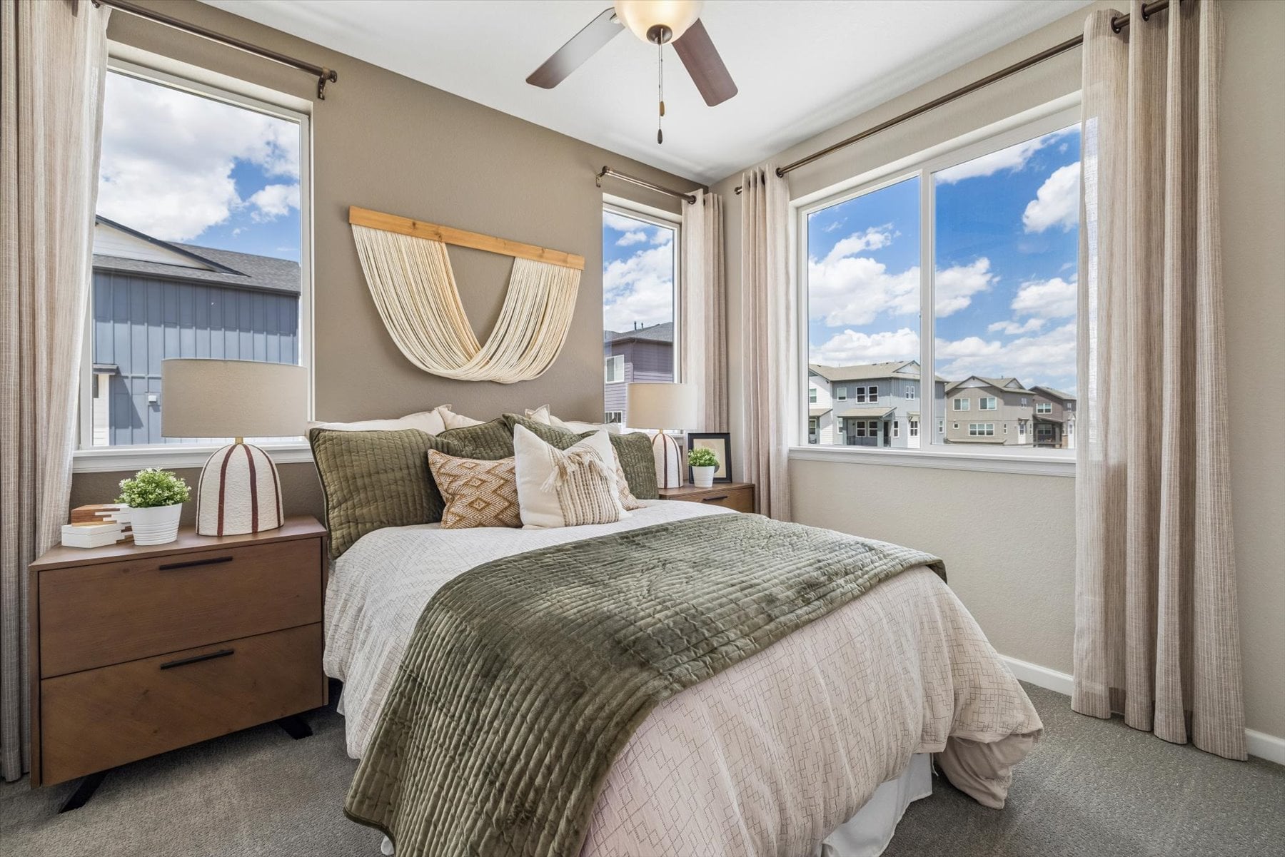 A bedroom with a large window.