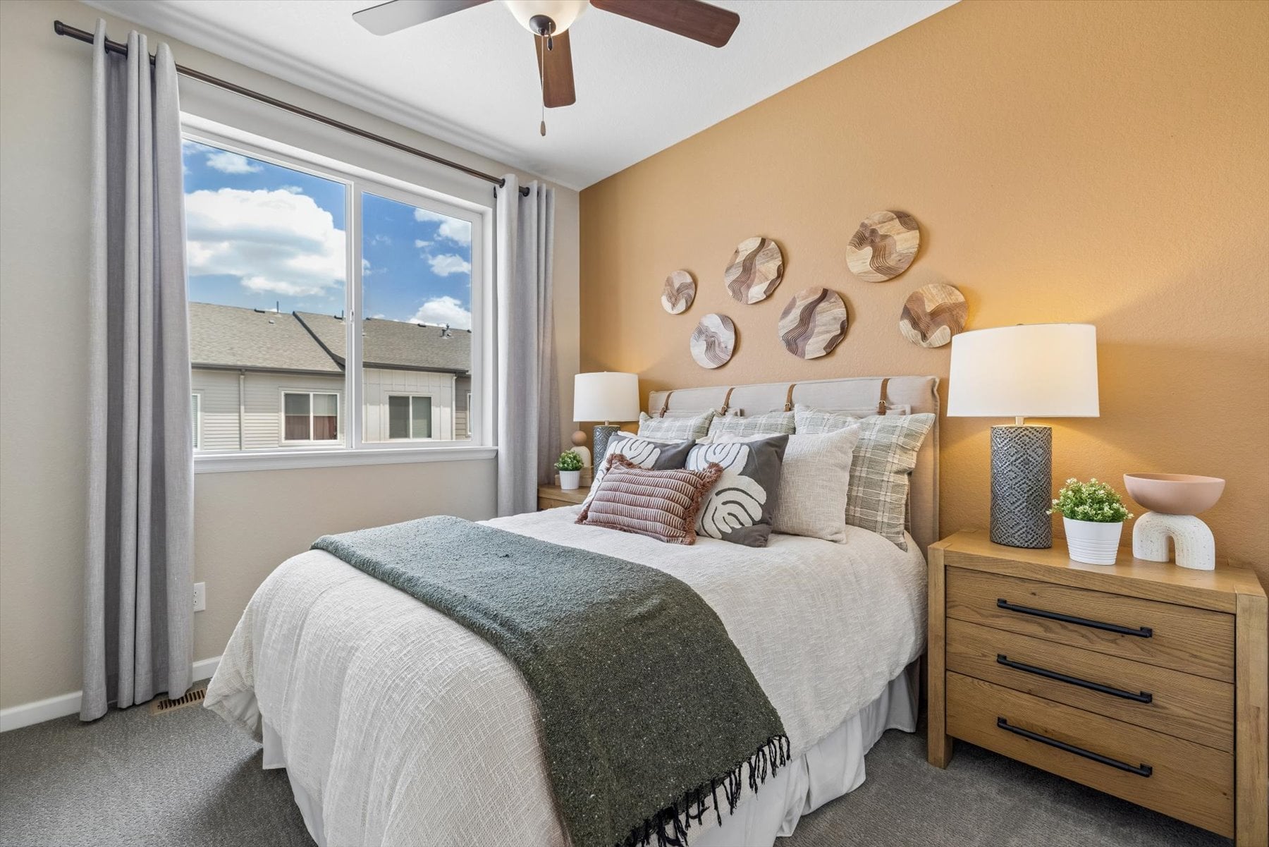 A bedroom with a large window.