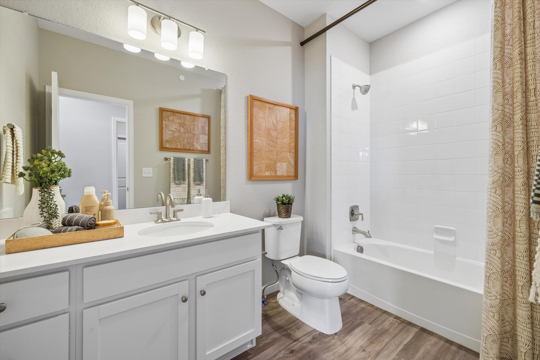 A bathroom with a tub sink and toilet.