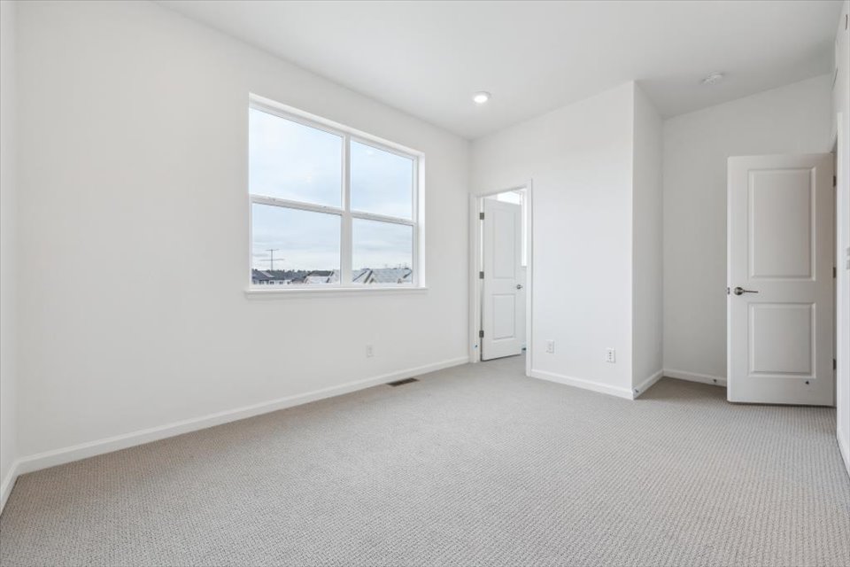 A room with white walls and a window.