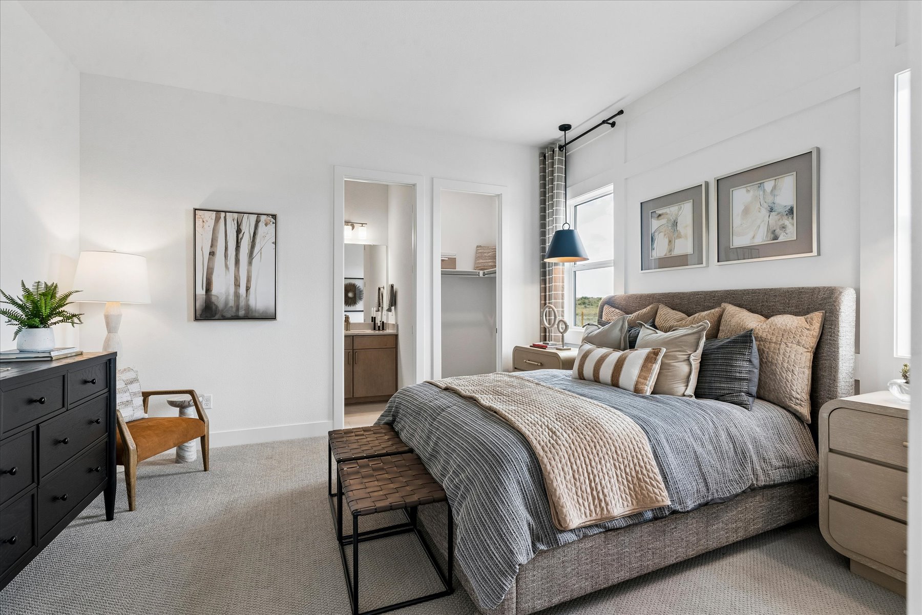 A bedroom with a bed and furniture.