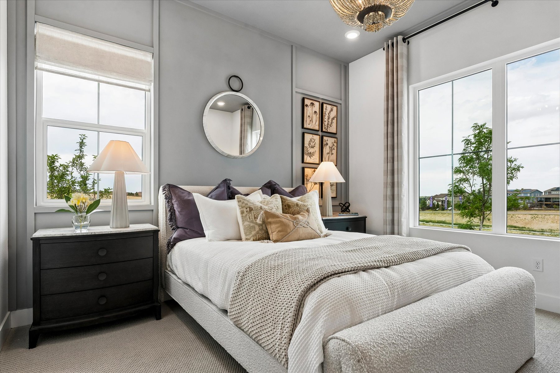 A bedroom with a large window.