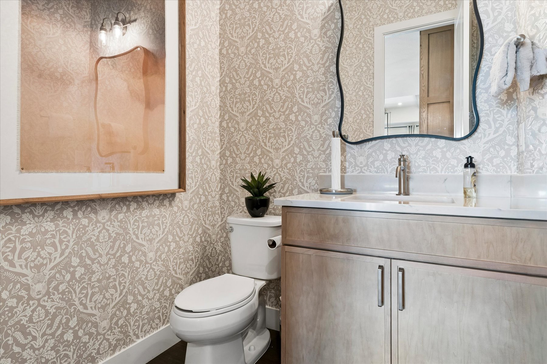A bathroom with a toilet and sink.