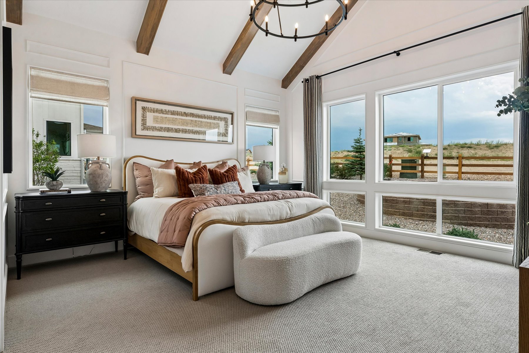 A bedroom with a large window.