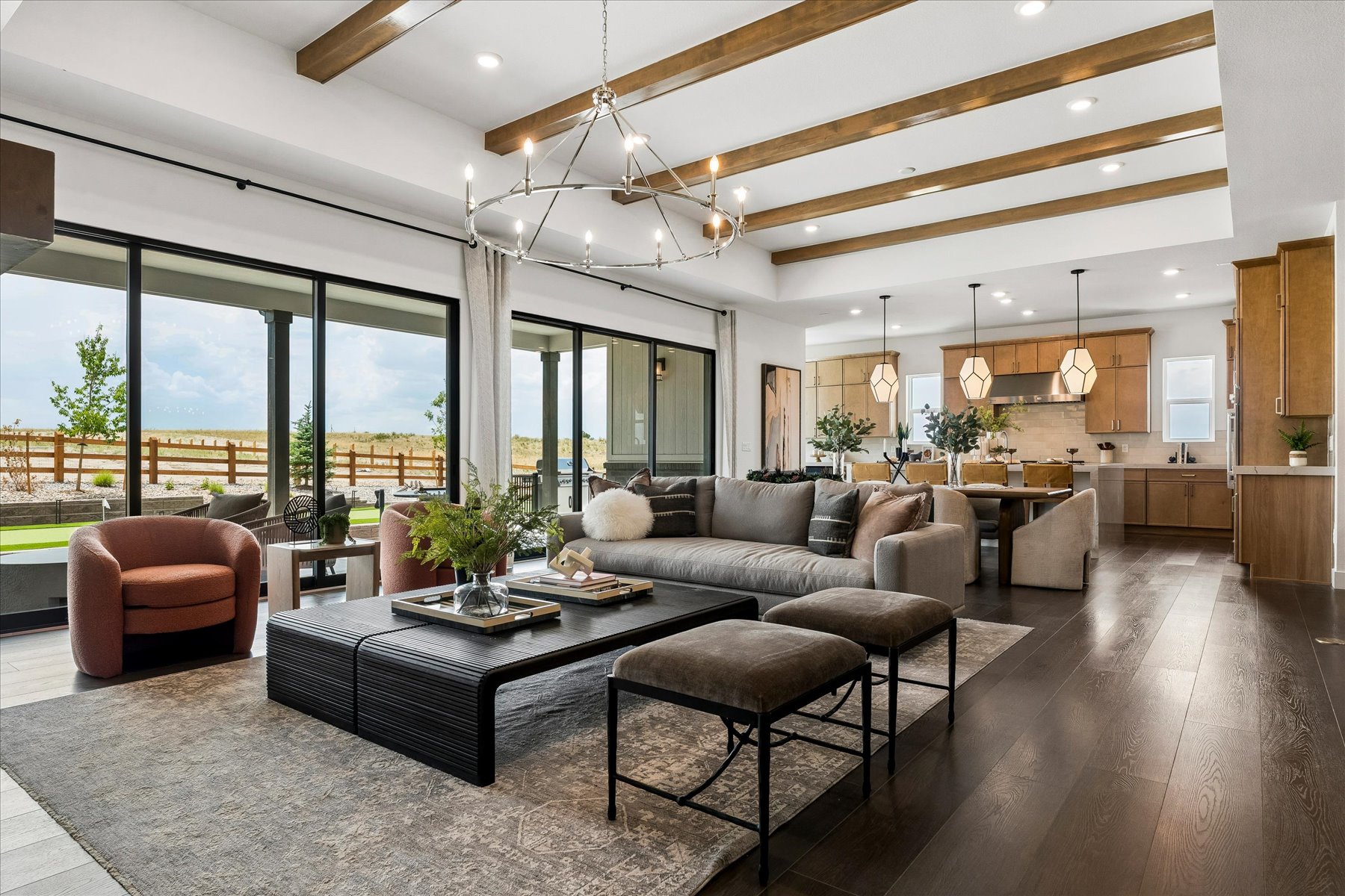 A large living room with a large chandelier and a large window.