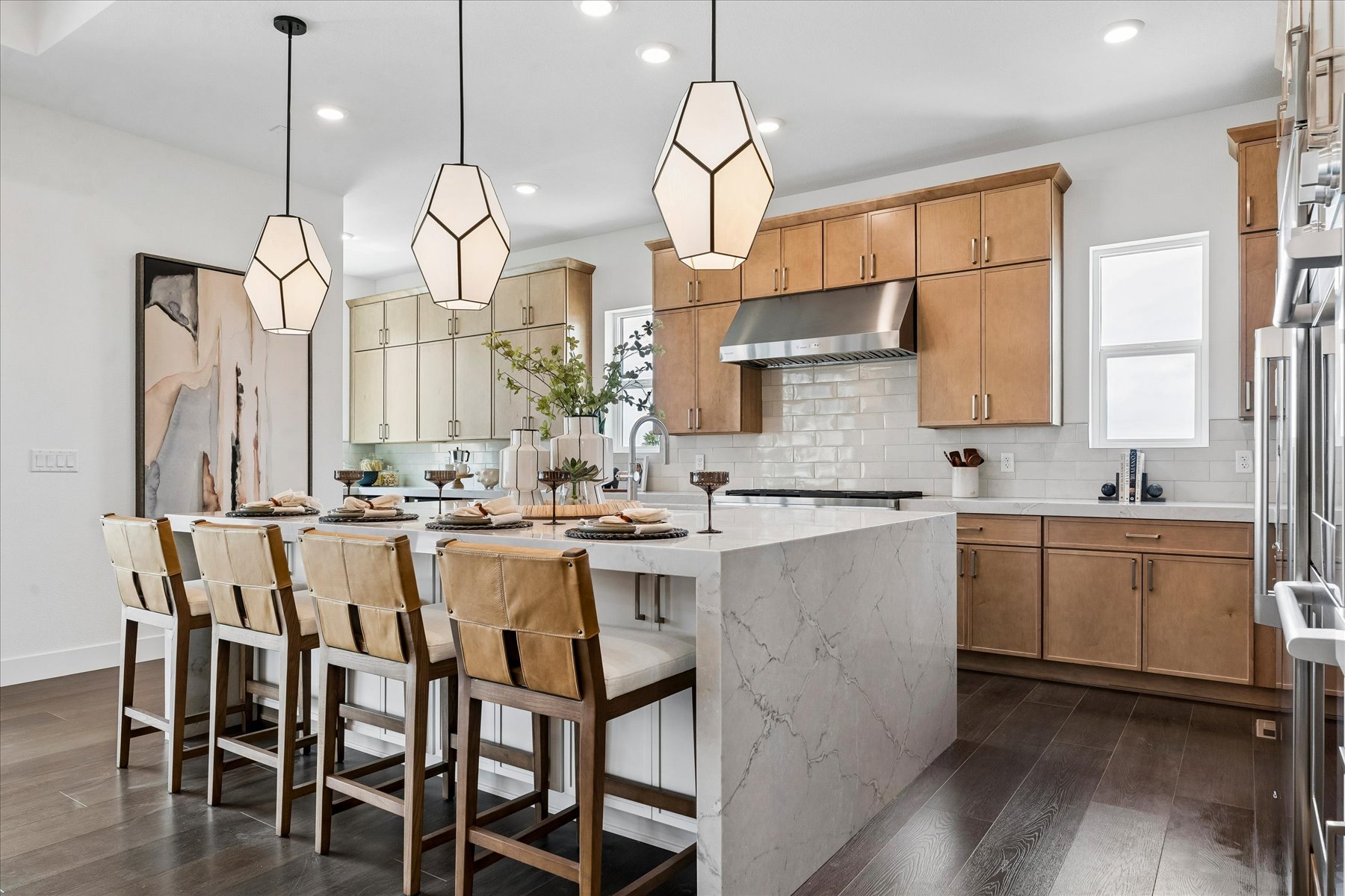 A kitchen with a table and chairs.