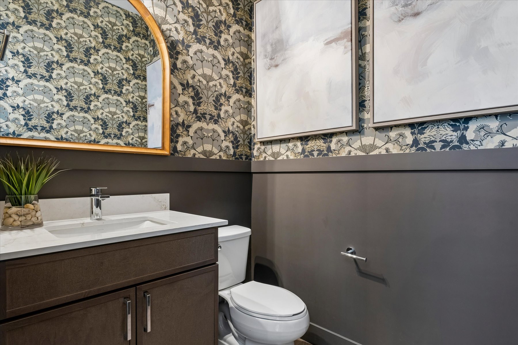 A bathroom with a large mirror.