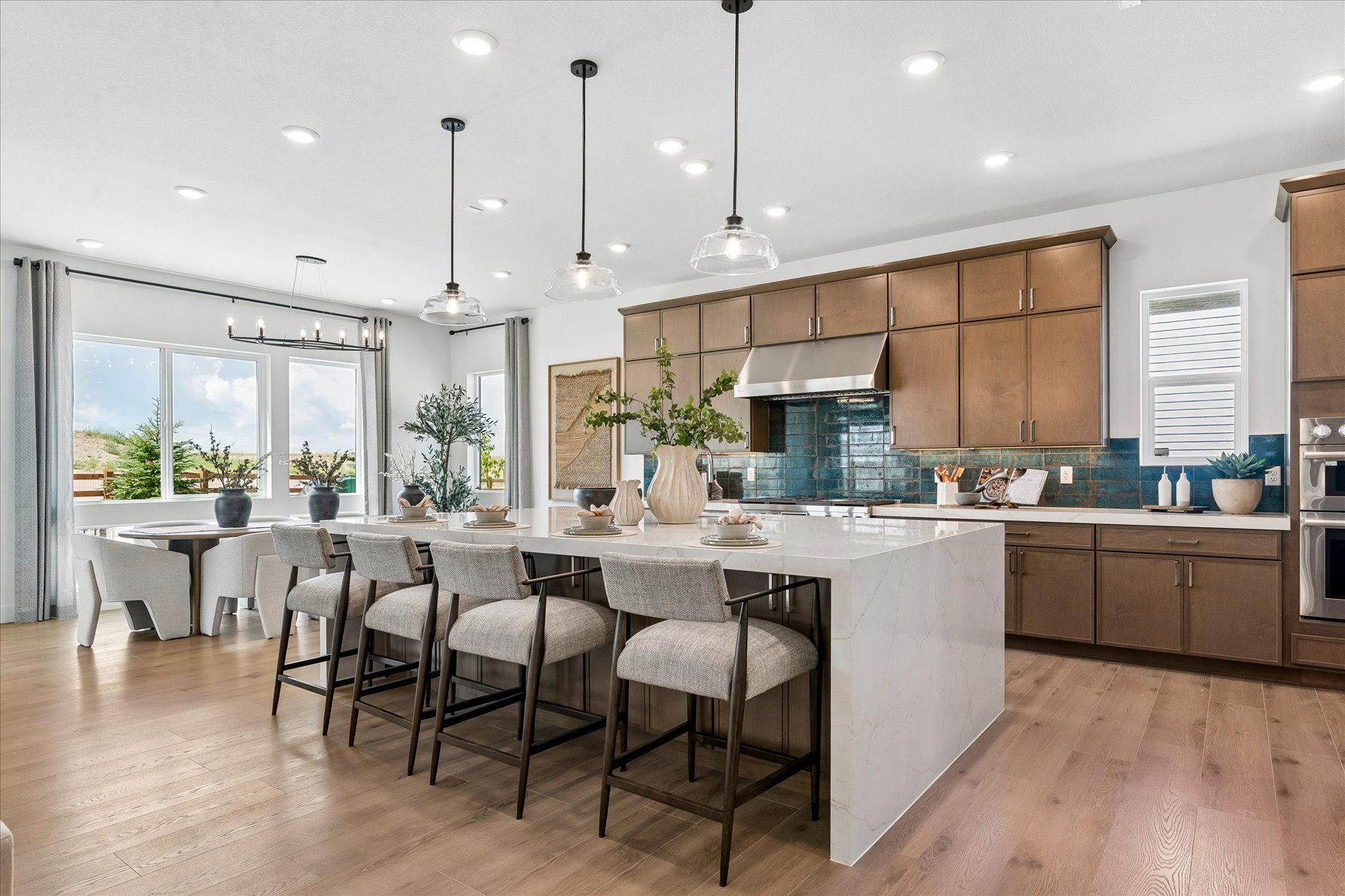 A kitchen with a bar and chairs.