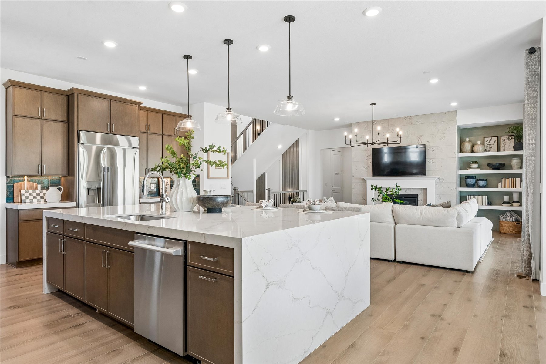 A kitchen with a white couch and a white table.