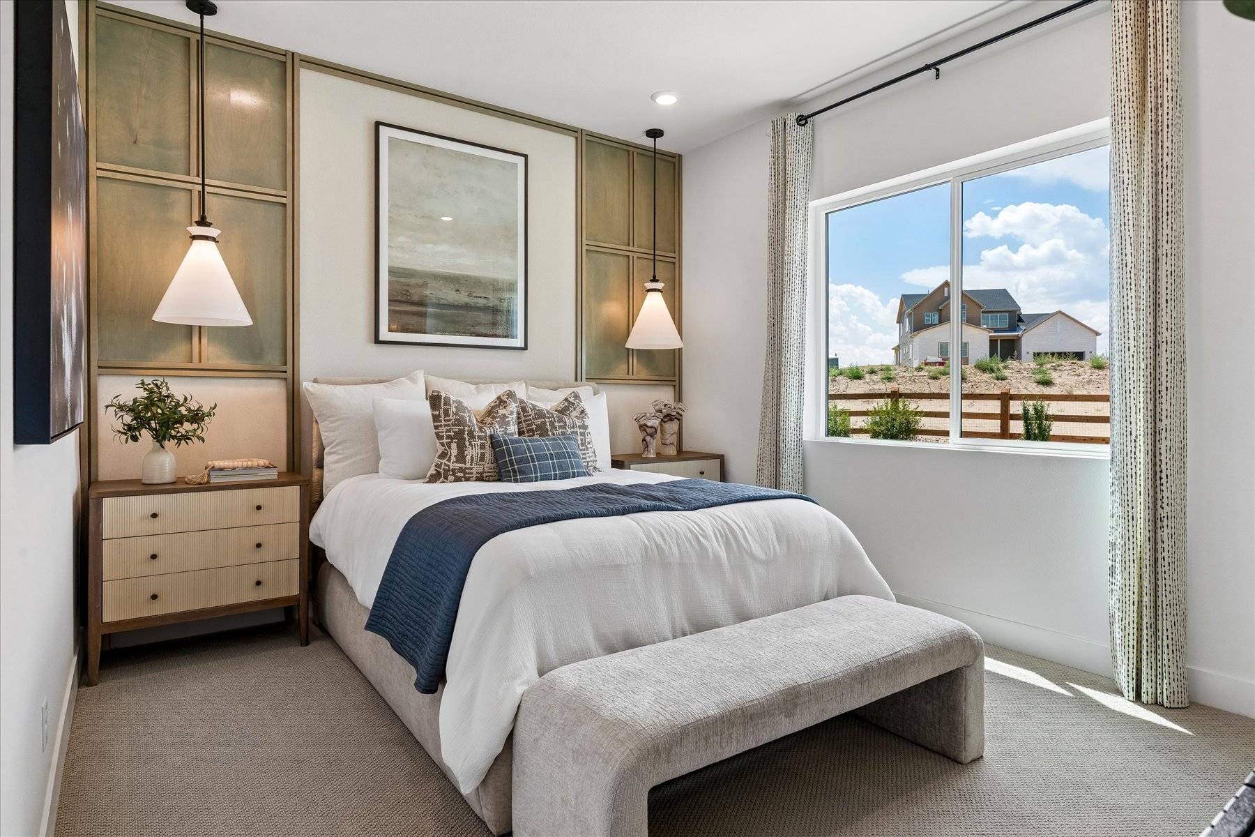 A bedroom with a large window.