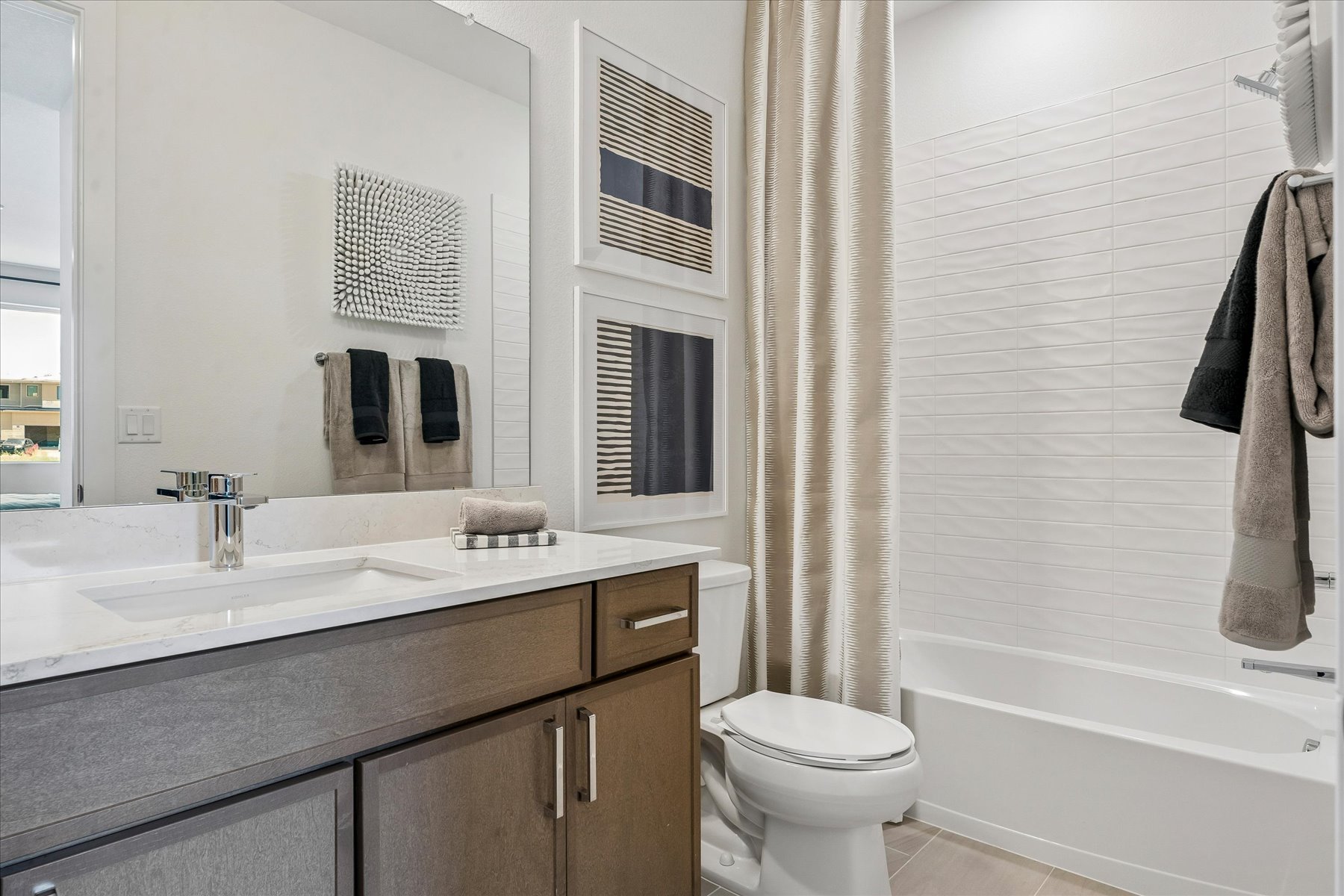 A bathroom with a tub sink and toilet.