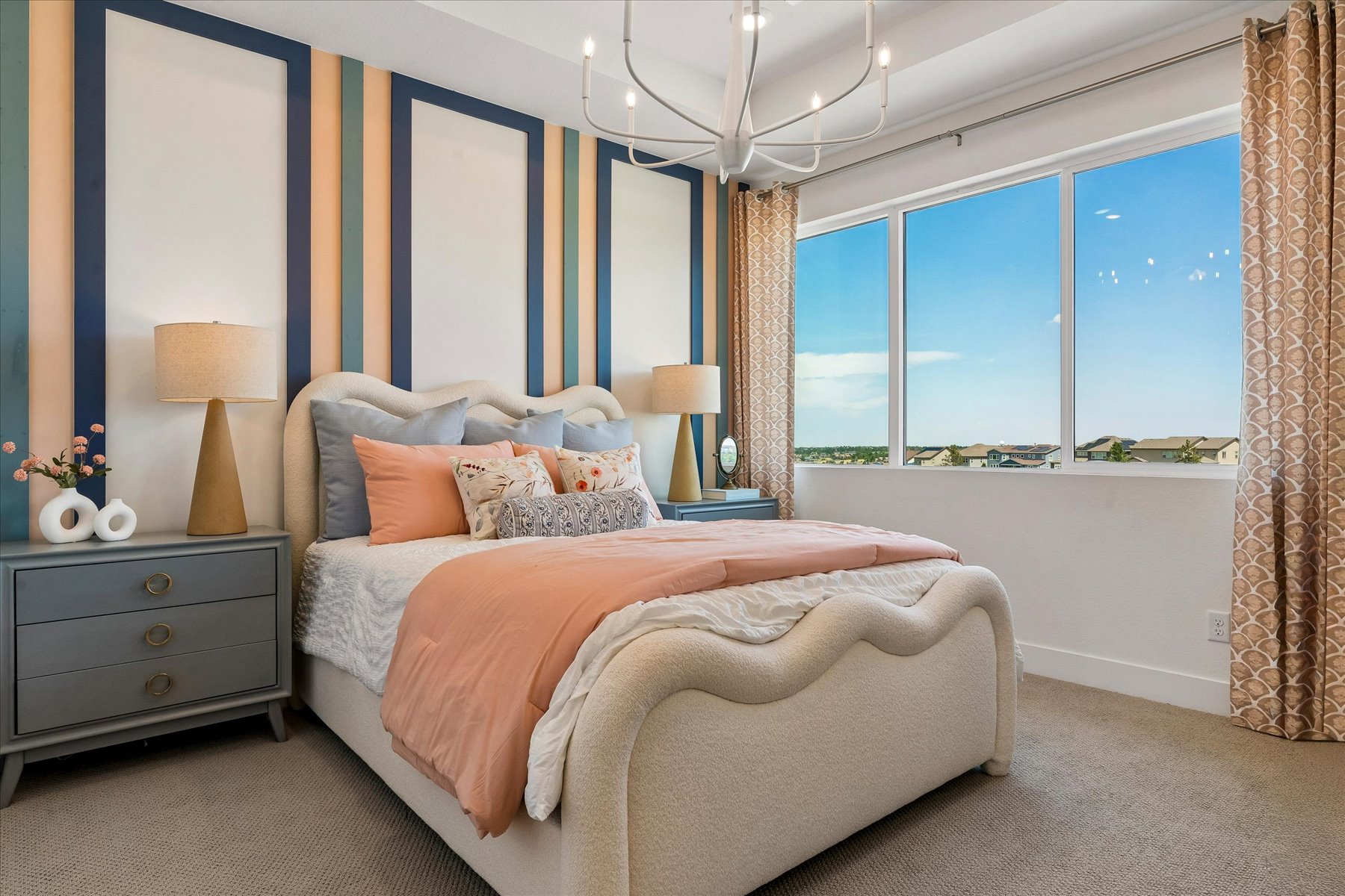 A bedroom with a large window.