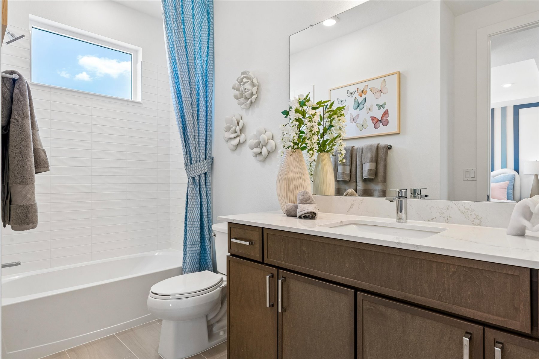 A bathroom with a tub sink and toilet.