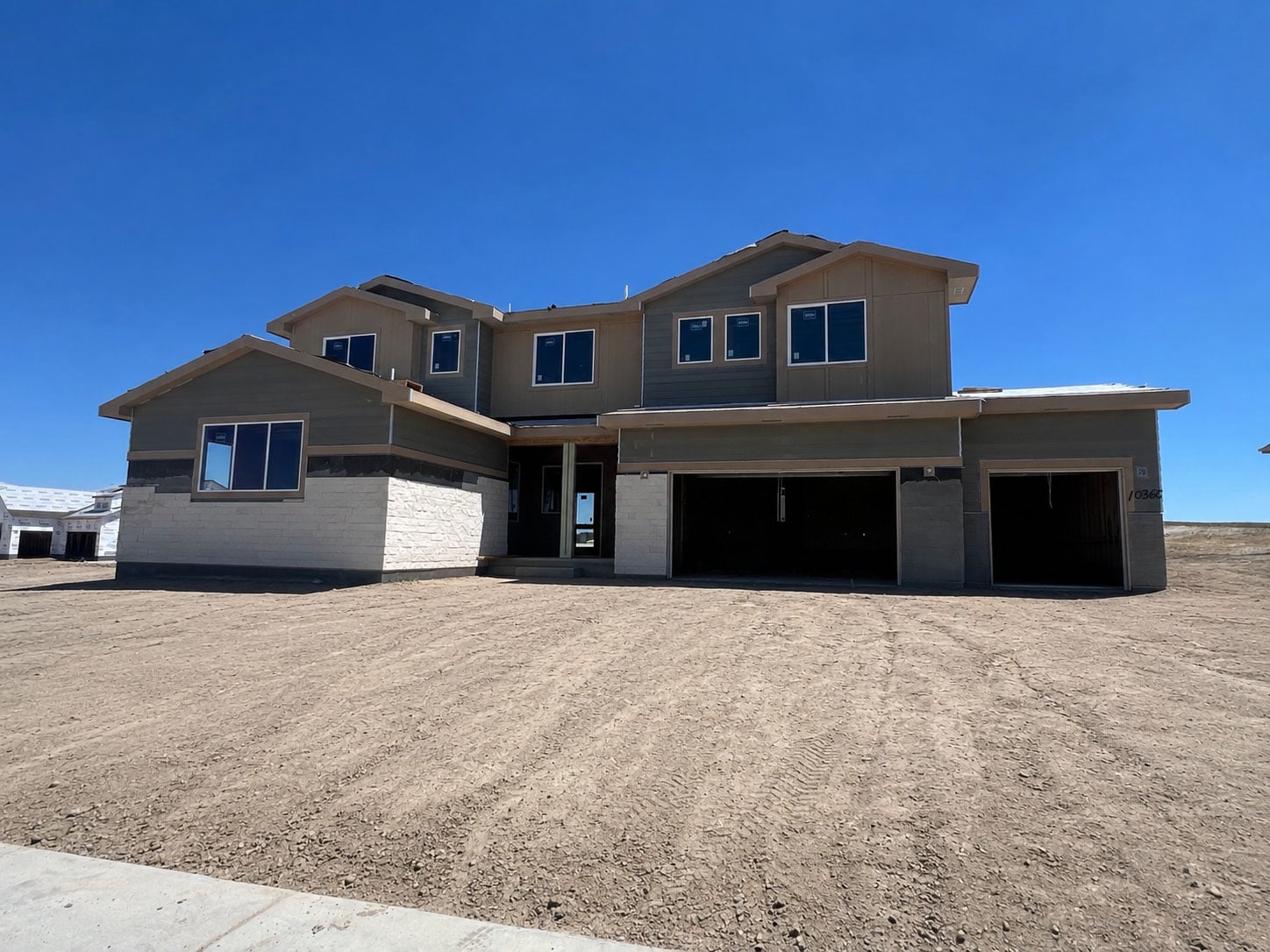 A house with a dirt lot.