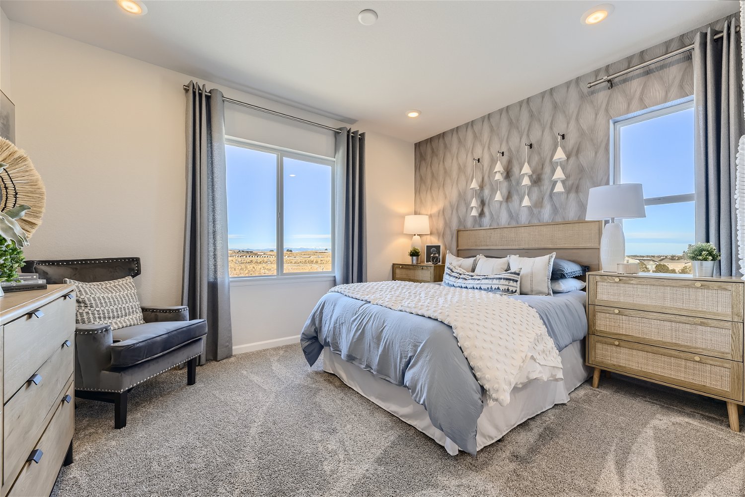 A bedroom with a bed and a chair.