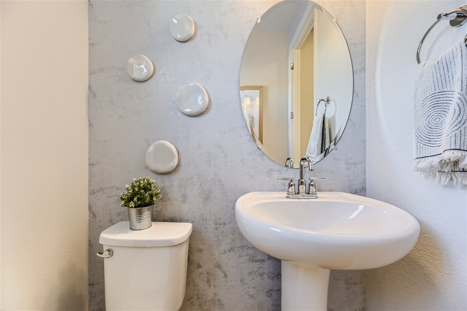 A bathroom with a round mirror.