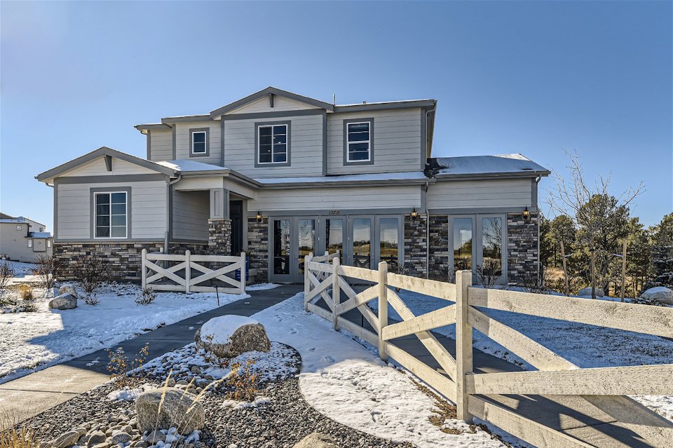 A house with a fence in the front.