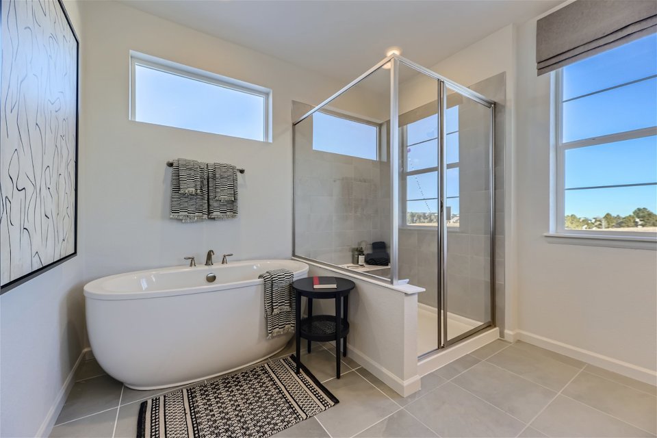 A bathroom with a tub and shower.