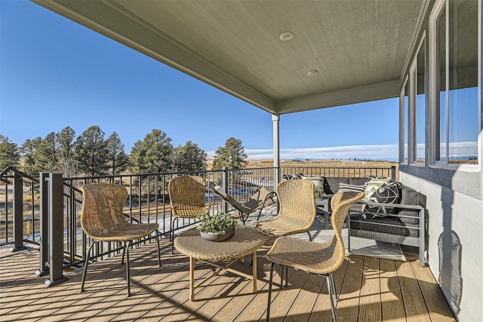 A deck with chairs and a table.