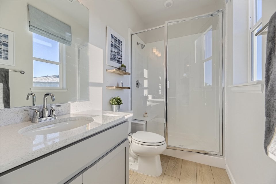A bathroom with a sink toilet and shower.