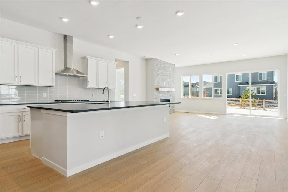 A kitchen with white cabinets.