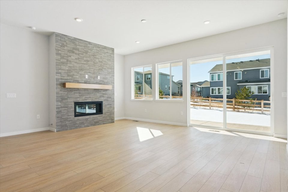 A room with a fireplace and a wood floor.