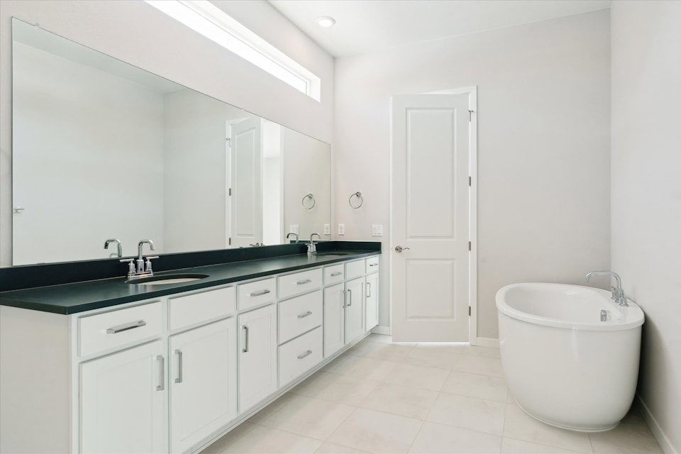 A bathroom with a tub sink and toilet.