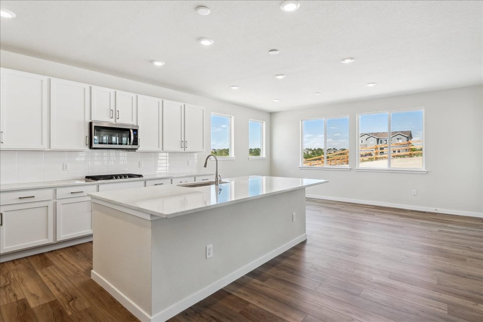 A kitchen with white cabinets.
