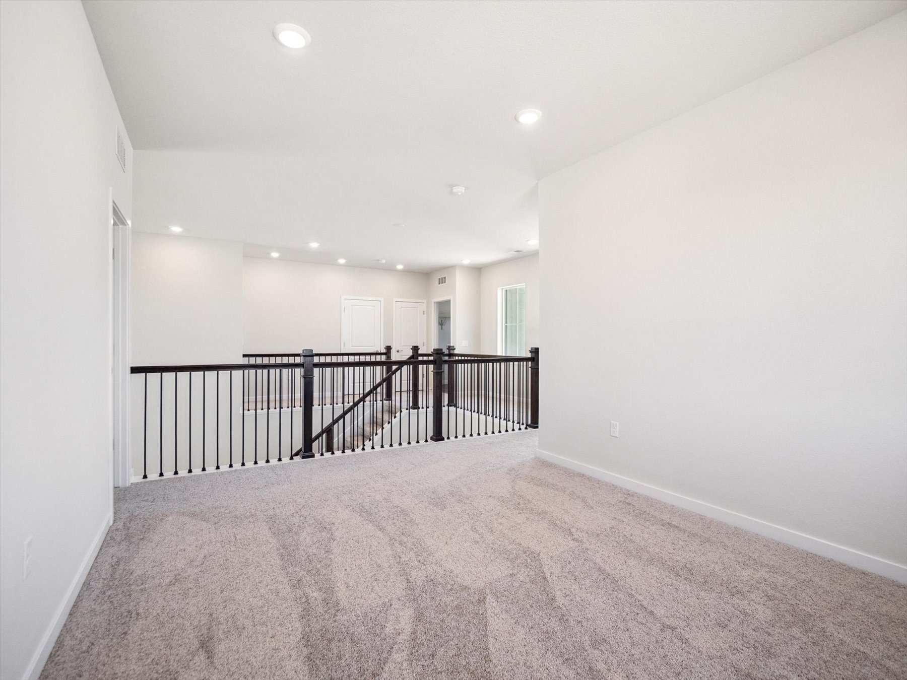A hallway with a railing.
