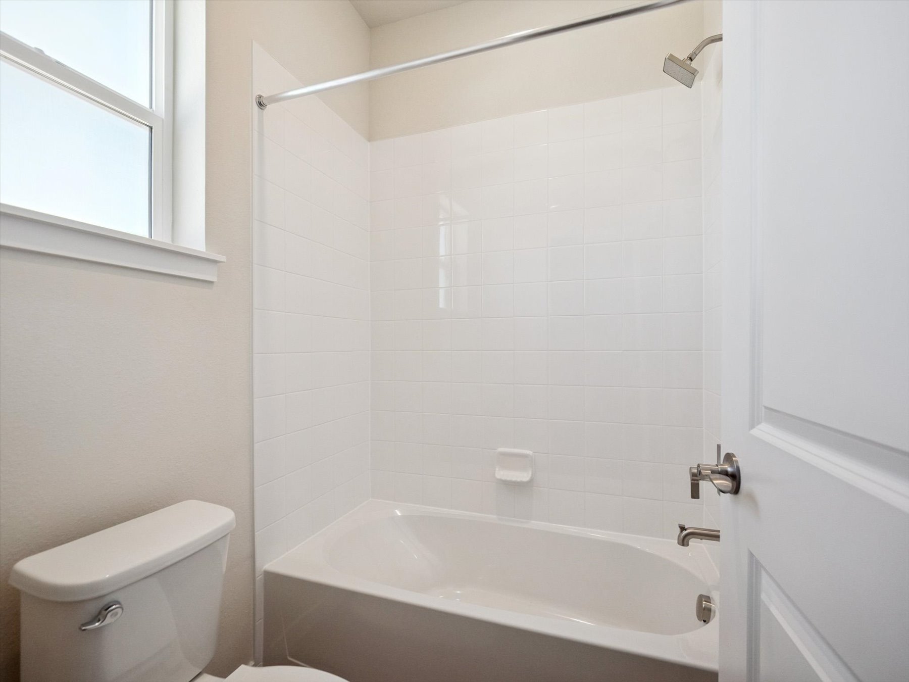 A bathroom with a bathtub and toilet.