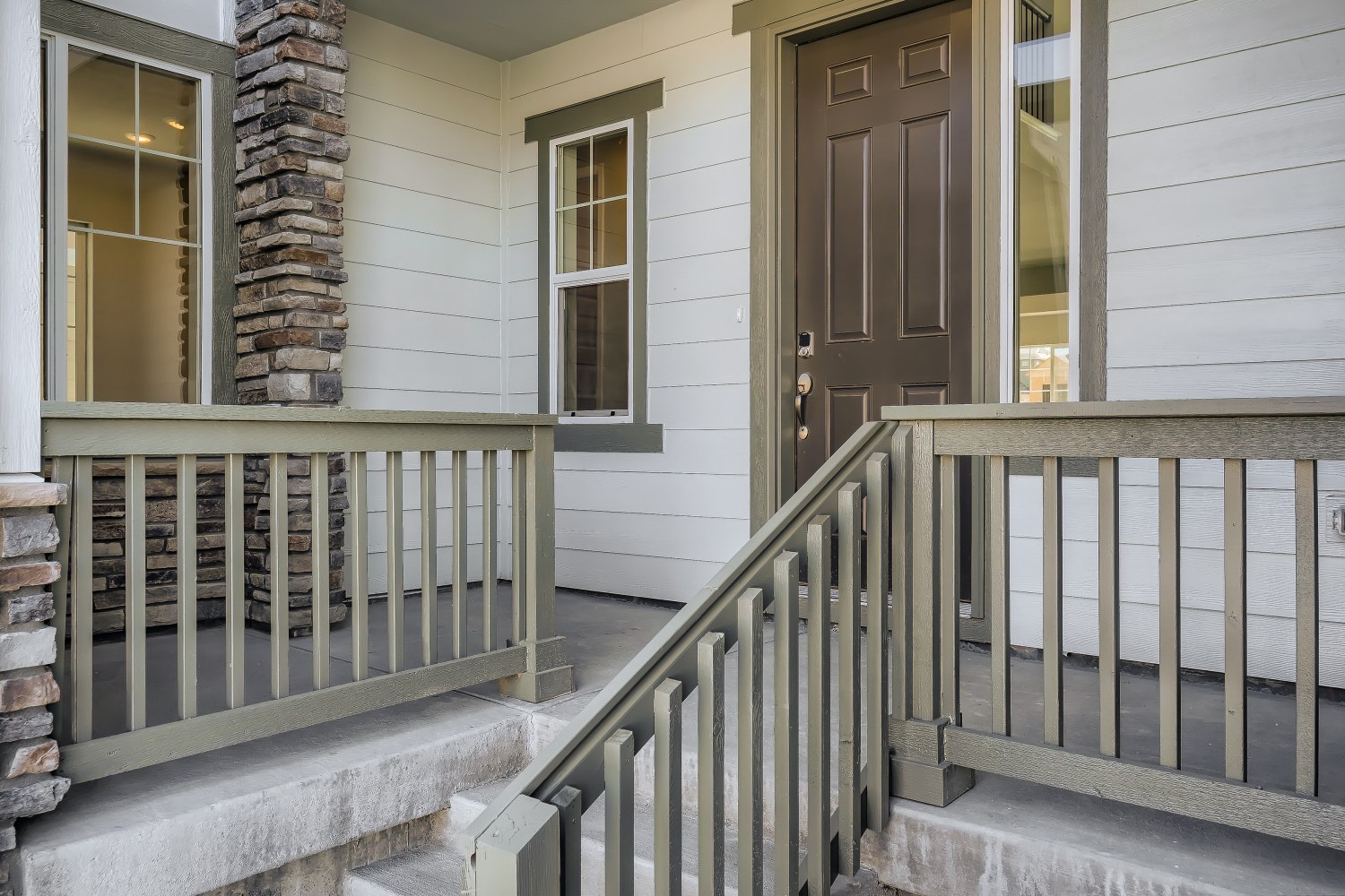 A white house with a wood railing.