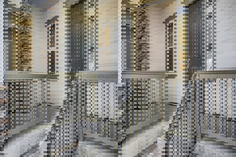 A white house with a wood railing.