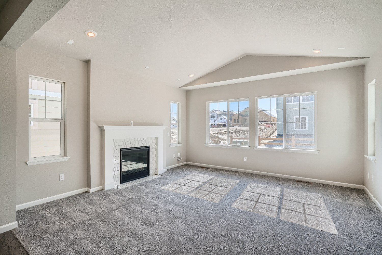 A room with a fireplace and a window.