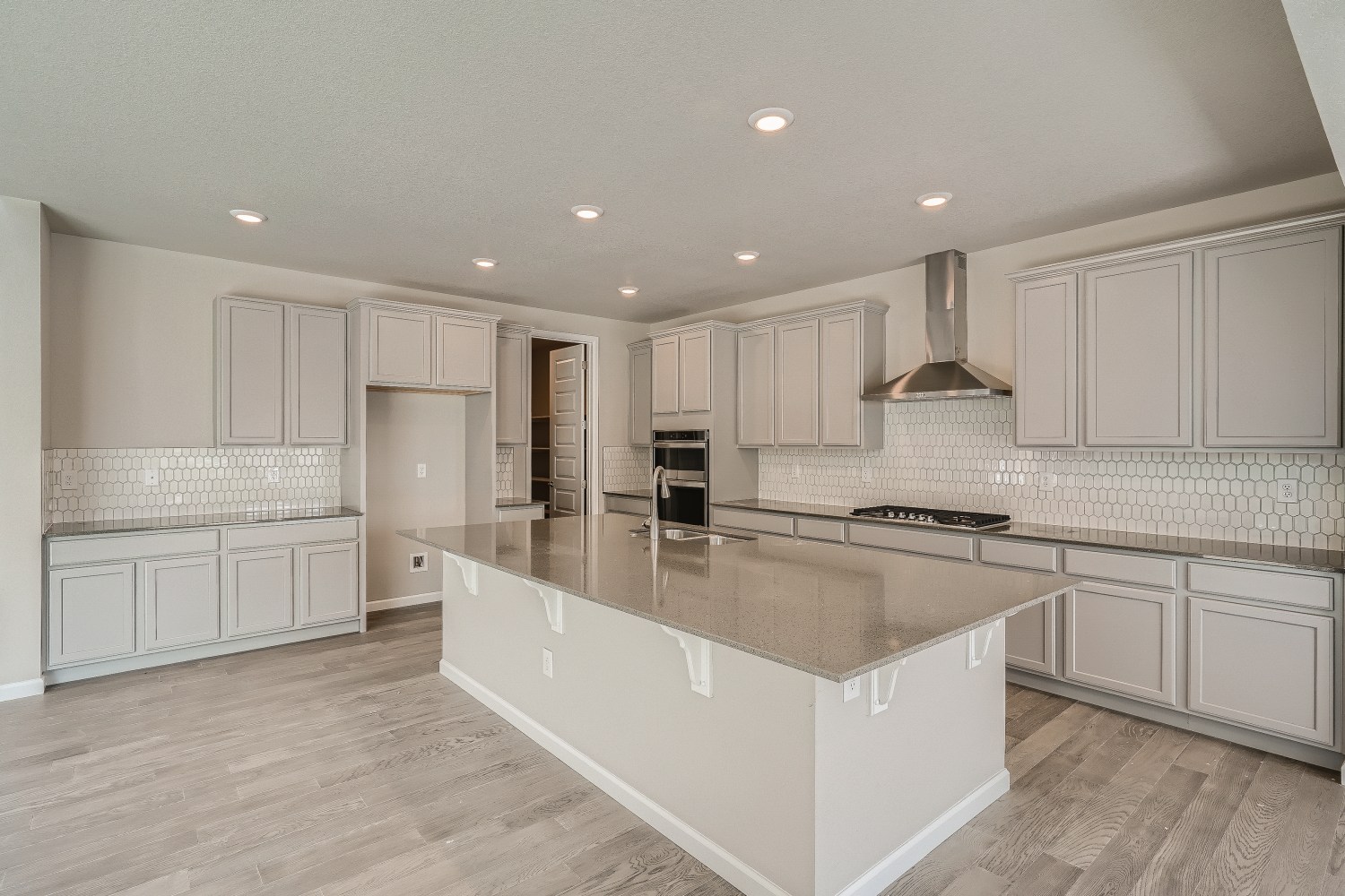 A kitchen with white cabinets.