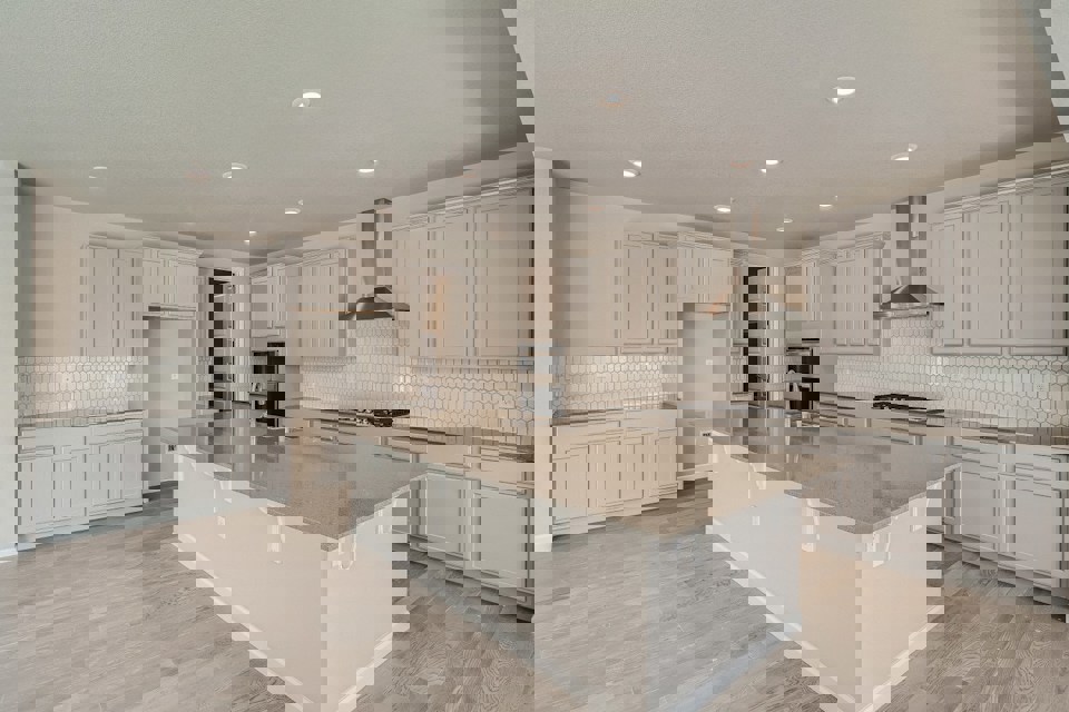 A kitchen with white cabinets.