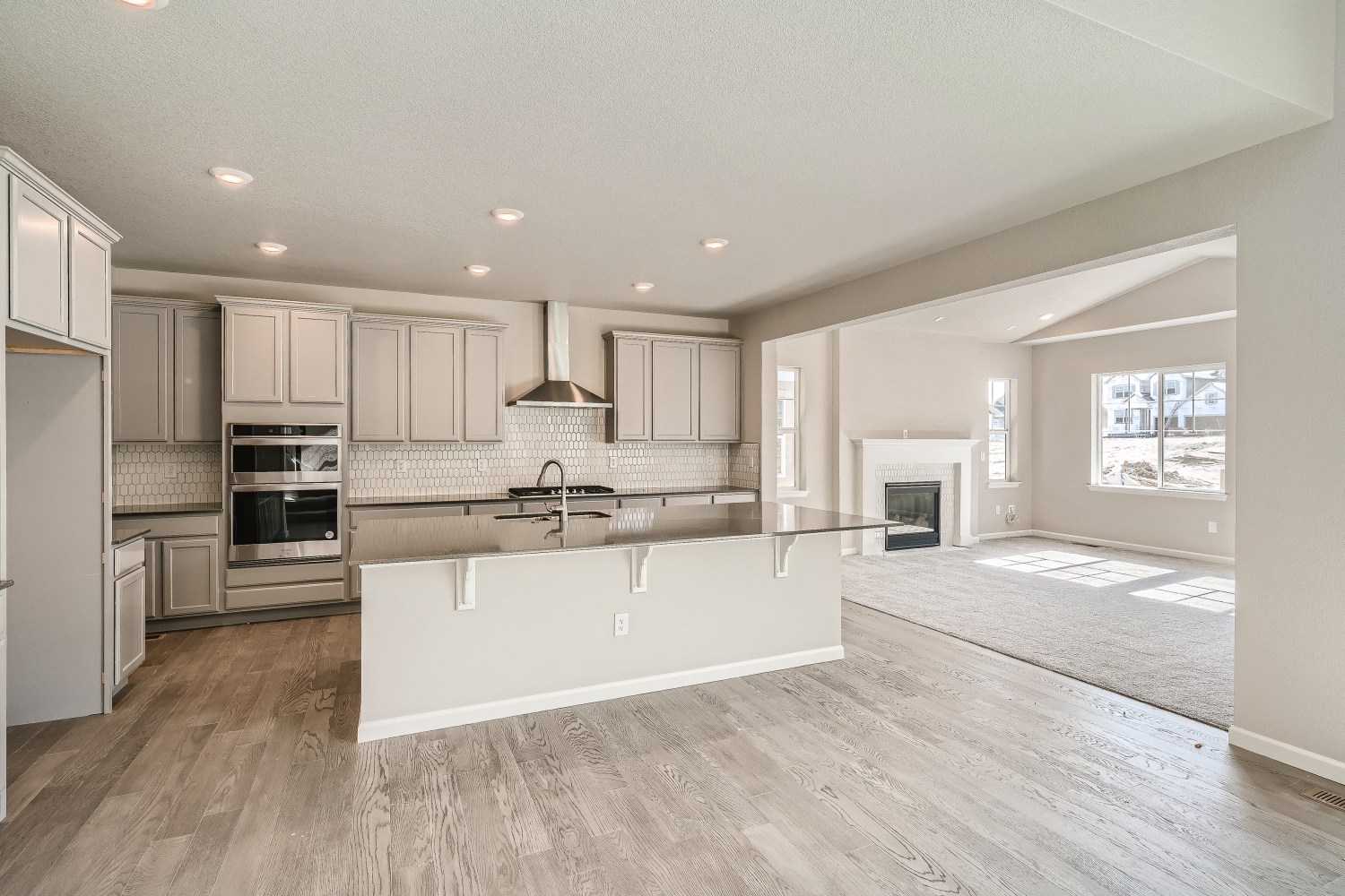 A kitchen with white cabinets.