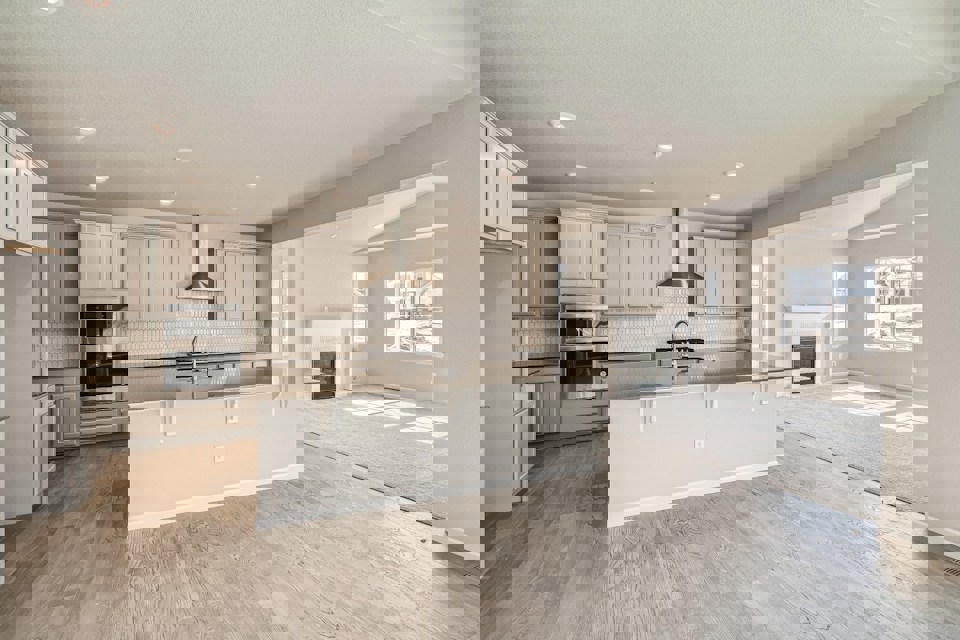 A kitchen with white cabinets.