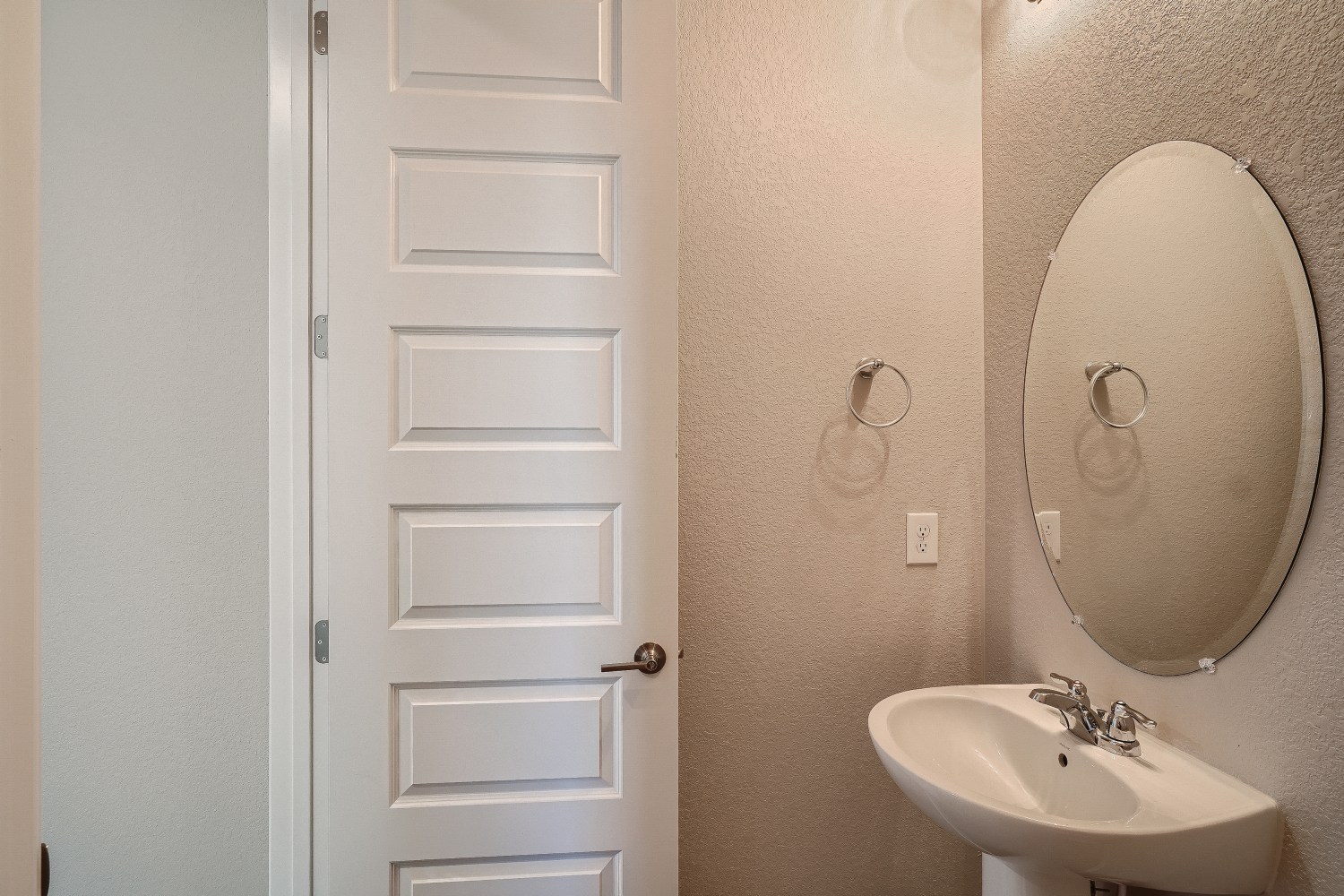 A bathroom with a mirror and sink.