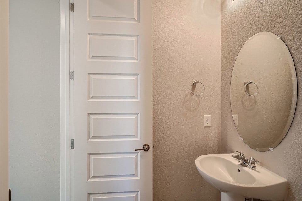 A bathroom with a mirror and sink.