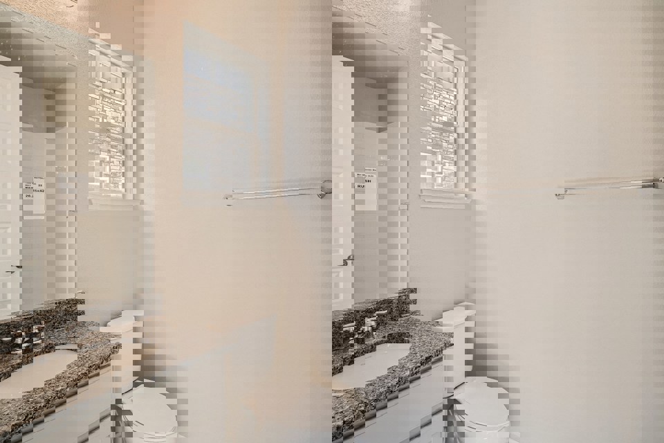 A bathroom with a sink and toilet.