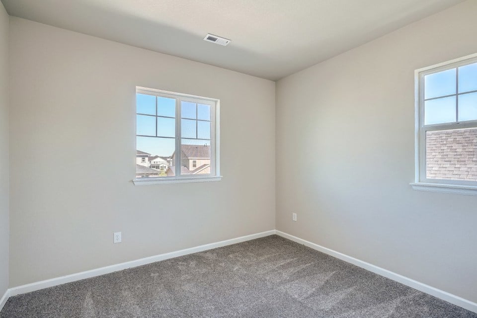 A room with windows and a carpet.