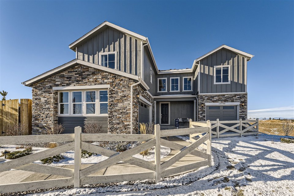 A house with a fence in front.