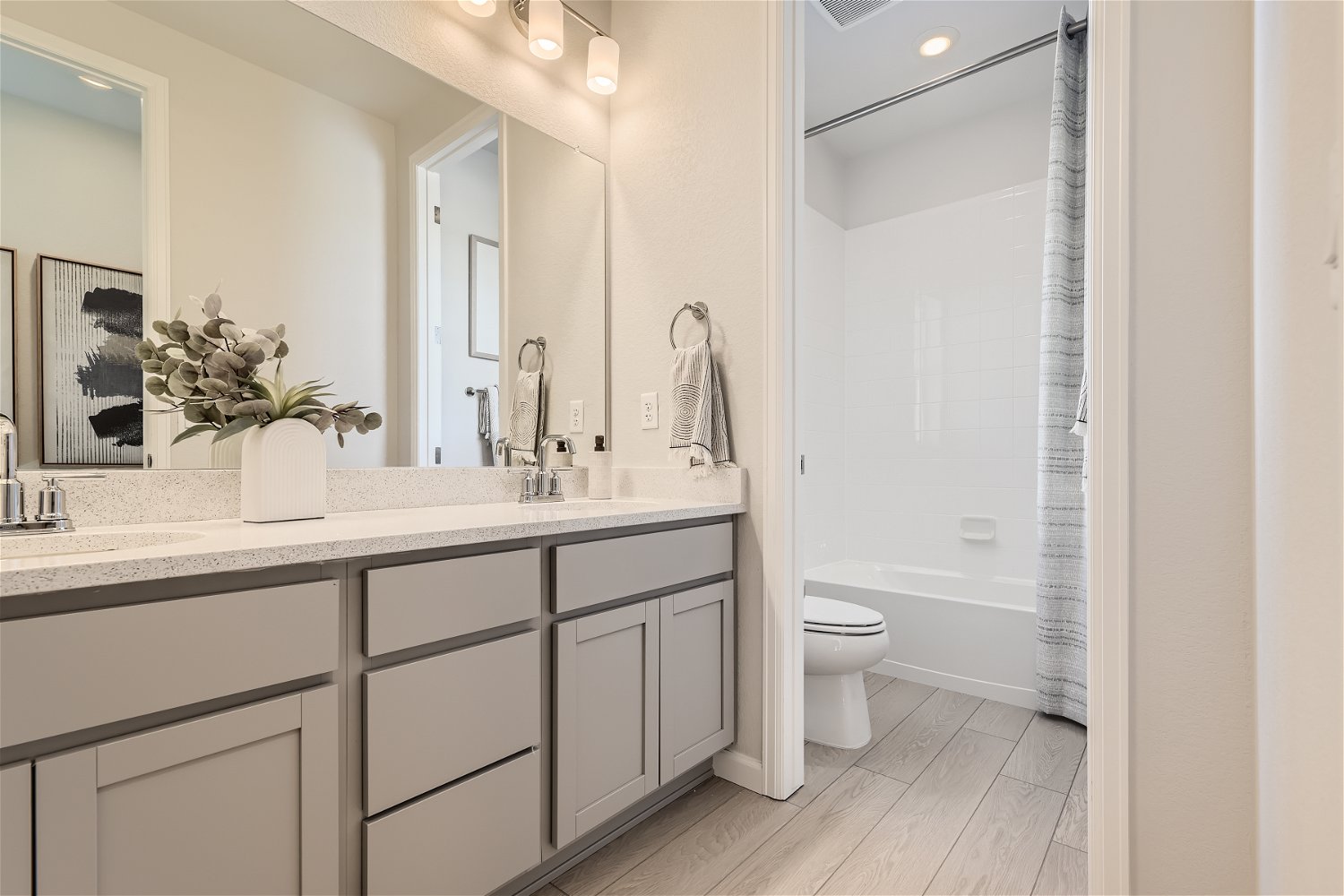A bathroom with a tub sink and toilet.
