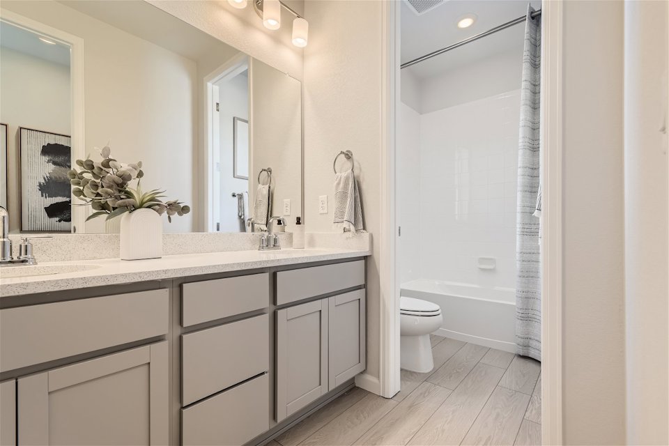 A bathroom with a tub sink and toilet.