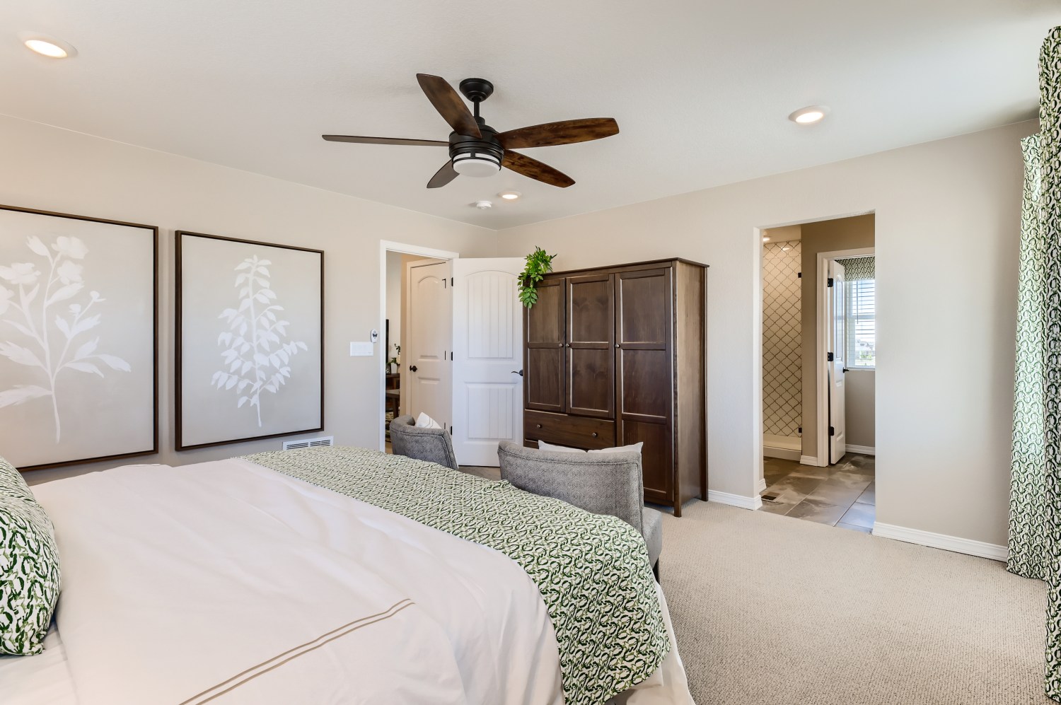 A bedroom with a bed and a fan.