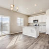 Great room and kitchen of the Fraser floor plan by Century Communities