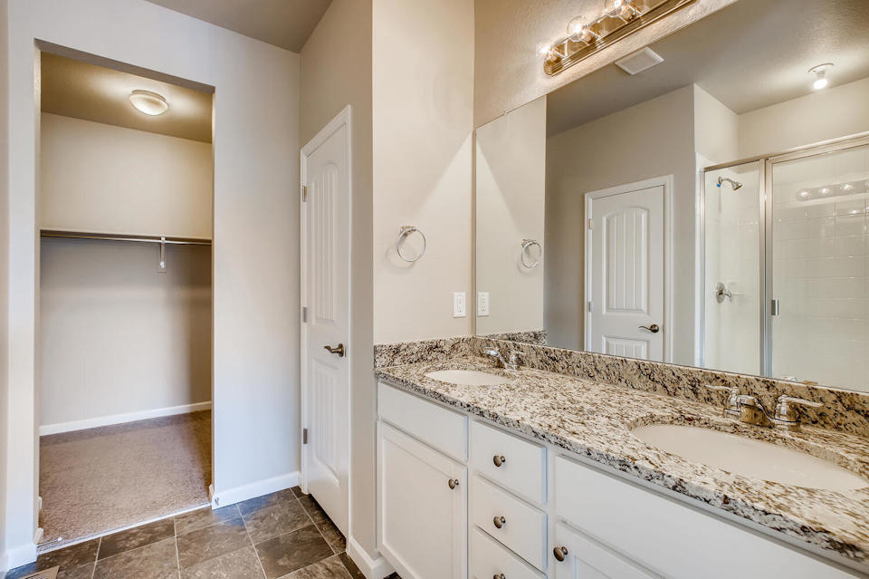 A bathroom with a marble countertop.
