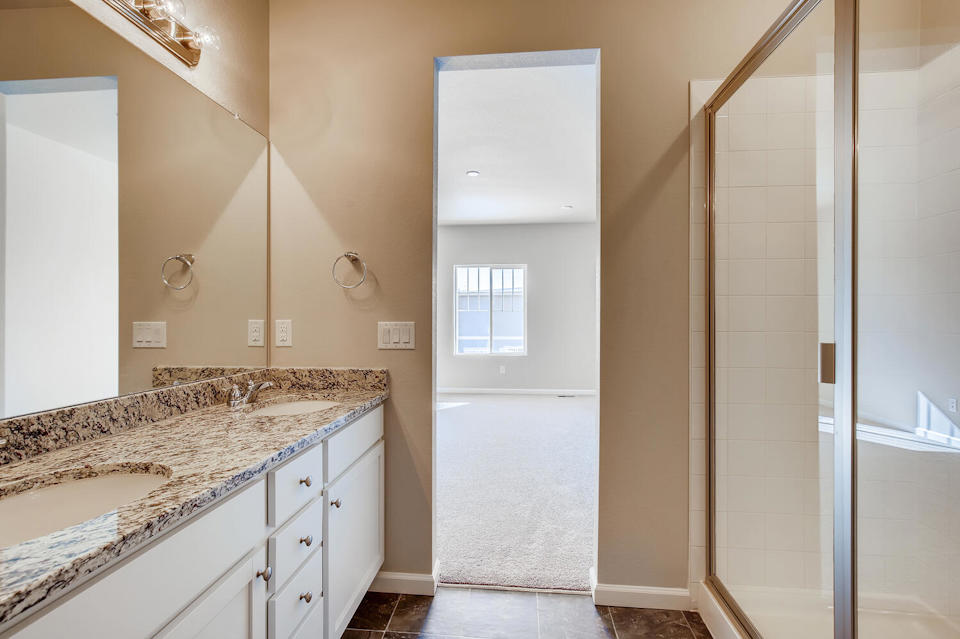 A bathroom with a marble countertop.