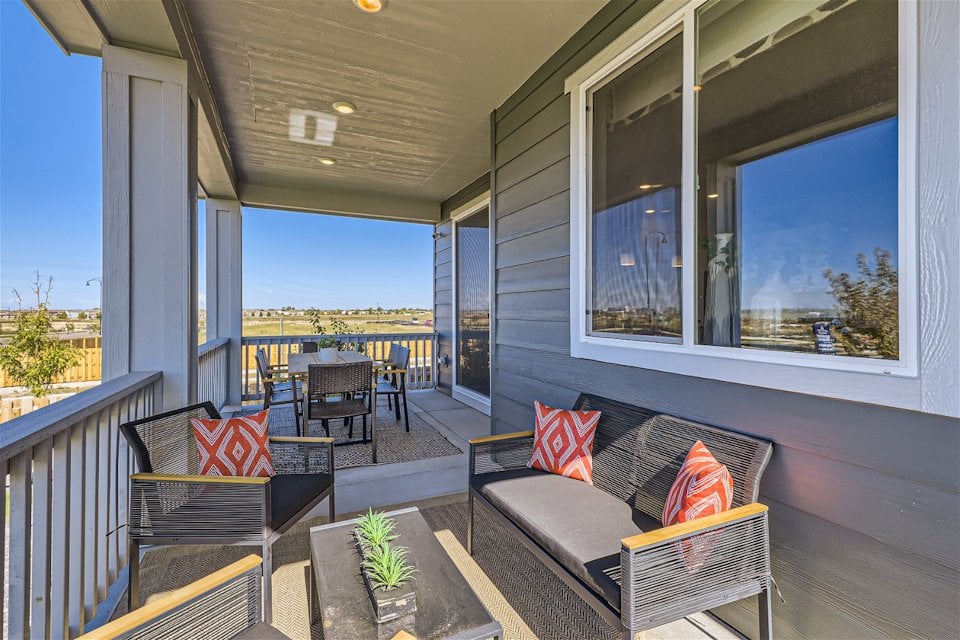 A deck with a couch and chairs.